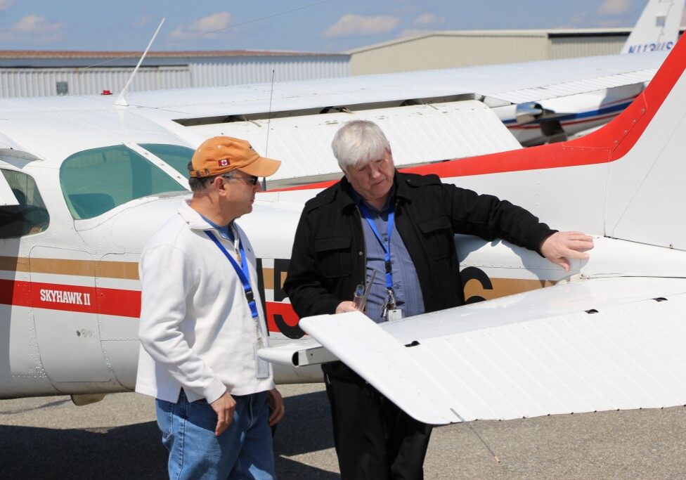 Instructor and student inspecting an airplane during structured flight lessons at AeroVenture.